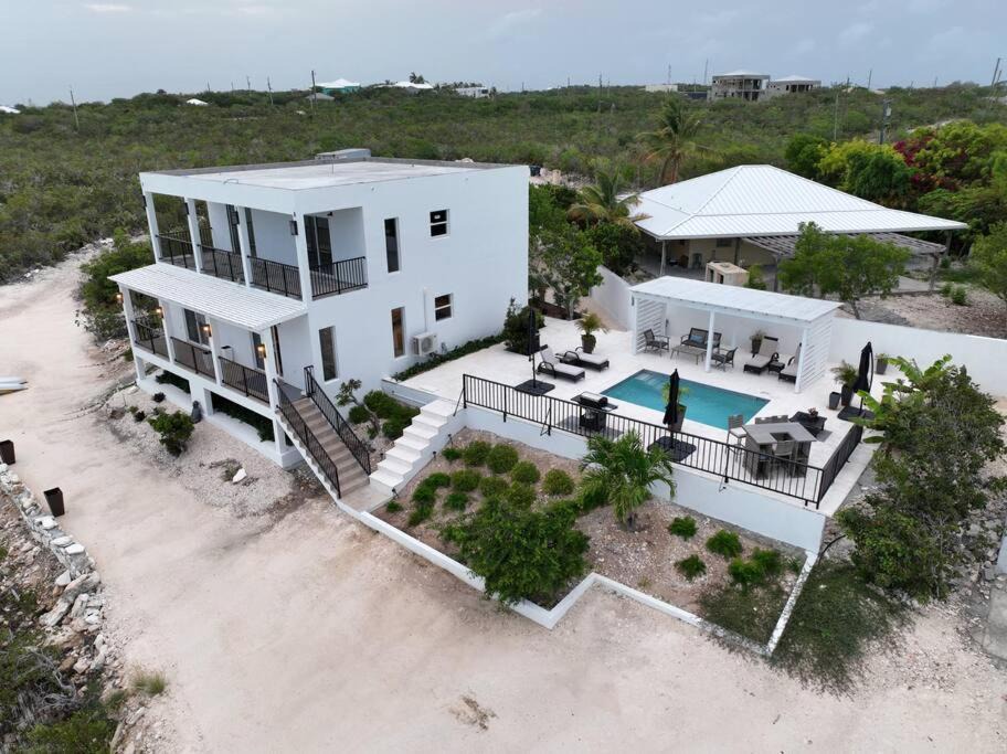 Venetian Road Settlement Villa | White Modern Flamingo Lake Villa