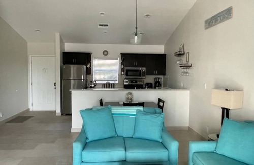 Wheeland Settlement Condo | “Coastal Bliss: Stunning 2-Bedroom Condo with breathtaking Beach and Pool Views”