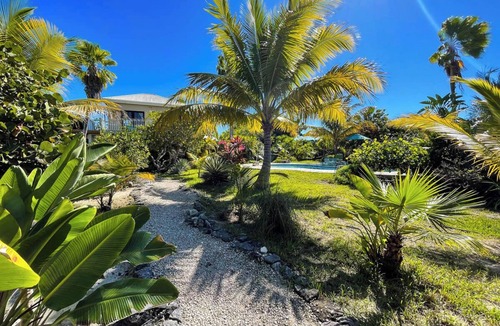 Leeward Settlement Apartment | Tropical Oasis Retreat: Romantic Upstairs Unit with Pool View and Balcony